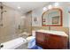 Modern bathroom featuring a tiled shower, updated vanity, and stylish mirror and lighting fixtures at 5118 Bottlebrush Run, Broomfield, CO 80023