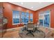 Cozy dining area featuring natural light from three windows and a sliding glass door, complemented by stylish furnishings at 5118 Bottlebrush Run, Broomfield, CO 80023