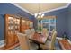 Elegant dining room with a large wooden table, upholstered chairs, and a display cabinet with decorative items at 5118 Bottlebrush Run, Broomfield, CO 80023