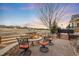 Outdoor firepit with circular seating in a backyard with chairs and scenic views at 5118 Bottlebrush Run, Broomfield, CO 80023