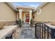 Charming front entrance with stone pathway, complemented by manicured plants and decorative ironwork at 5118 Bottlebrush Run, Broomfield, CO 80023