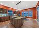 Well-equipped kitchen with a central island, custom cabinetry, and large windows providing a bright and airy atmosphere at 5118 Bottlebrush Run, Broomfield, CO 80023