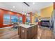 Modern kitchen featuring a large island, stainless steel appliances, and an adjacent breakfast nook with ample natural light at 5118 Bottlebrush Run, Broomfield, CO 80023