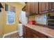 Well-organized laundry room with a stacked washer and dryer, ample cabinet space, and a functional countertop at 5118 Bottlebrush Run, Broomfield, CO 80023