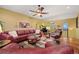 Cozy living room featuring a comfortable leather sofa, a grand piano, and a warm color palette at 5118 Bottlebrush Run, Broomfield, CO 80023