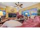 Inviting living room with a fireplace, plush leather seating, and large windows offering scenic views at 5118 Bottlebrush Run, Broomfield, CO 80023