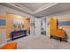 Playroom area with colorful accents, decorative wall art, and built-in shelving, creating a fun, imaginative atmosphere at 5118 Bottlebrush Run, Broomfield, CO 80023