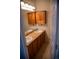Bathroom with double sink vanity, wooden cabinets, and tiled floor at 16180 E Geddes Ln # 14, Aurora, CO 80016