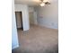 Large bedroom with carpeted flooring, neutral paint and access to multiple doors at 16180 E Geddes Ln # 14, Aurora, CO 80016