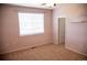 Neutral bedroom offers a ceiling fan, natural light from the window, and neutral carpet at 16180 E Geddes Ln # 14, Aurora, CO 80016