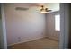 Bright bedroom featuring a ceiling fan, window, and neutral carpet at 16180 E Geddes Ln # 14, Aurora, CO 80016