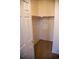 Walk-in closet features built-in shelves and hanging rods for ample storage at 16180 E Geddes Ln # 14, Aurora, CO 80016