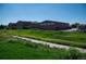 Exterior view of the brick building and surrounding green space under clear blue skies at 16180 E Geddes Ln # 14, Aurora, CO 80016