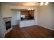 Open-concept living room with a modern fireplace and seamless flow into a well-equipped kitchen at 16180 E Geddes Ln # 14, Aurora, CO 80016