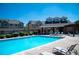 Community pool with lounge chairs and a pergola for shade at 16180 E Geddes Ln # 14, Aurora, CO 80016