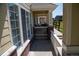 Covered porch with brick base, columns, white picket fence, and view of pathway at 16180 E Geddes Ln # 14, Aurora, CO 80016
