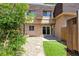 Exterior patio with sliding glass doors, artificial turf, rock bed and a privacy fence at 7755 E Quincy Ave # T2, Denver, CO 80237