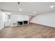 Finished basement with wood-look floors, a brick fireplace, and stairs leading to the upper level at 7755 E Quincy Ave # T2, Denver, CO 80237