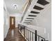 Bright entryway features stylish wood-look flooring, a wooden door, and a staircase at 7755 E Quincy Ave # T2, Denver, CO 80237