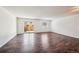 Bright living room with wood floors and a sliding glass door to the backyard at 7755 E Quincy Ave # T2, Denver, CO 80237