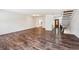 Spacious living room with dark, stained wood-look floors, white walls and modern lighting and entry way at 7755 E Quincy Ave # T2, Denver, CO 80237