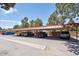 Assigned covered parking with several parking spaces under a red metal roof at 7755 E Quincy Ave # T2, Denver, CO 80237