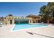 Community pool with tanning deck and clubhouse under a bright blue sky at 7755 E Quincy Ave # T2, Denver, CO 80237