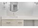 Bathroom featuring a modern vanity with a sleek sink and round mirror at 6455 E Bates Ave # 3-102, Denver, CO 80222