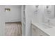 Bathroom vanity with modern faucet and storage, plus a view into the adjacent bedroom at 6455 E Bates Ave # 3-102, Denver, CO 80222