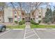 Building exterior of apartments and parking spaces with landscaped grounds at 6455 E Bates Ave # 3-102, Denver, CO 80222