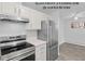 Updated kitchen with stainless steel appliances, white cabinets, and modern countertop at 6455 E Bates Ave # 3-102, Denver, CO 80222