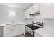 Modern kitchen with stainless steel stove, white cabinets and countertops with ample cooking space at 6455 E Bates Ave # 3-102, Denver, CO 80222