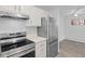 Bright kitchen featuring stainless steel appliances and a sleek refrigerator at 6455 E Bates Ave # 3-102, Denver, CO 80222