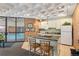 Charming kitchenette with a breakfast bar that is adjacent to the community pool at 6455 E Bates Ave # 3-102, Denver, CO 80222