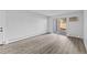 Spacious living area with luxury vinyl plank flooring and a sliding glass door to an outside patio at 6455 E Bates Ave # 3-102, Denver, CO 80222