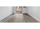Bright living room with luxury vinyl plank flooring and a sliding glass door to an outside patio at 6455 E Bates Ave # 3-102, Denver, CO 80222