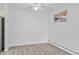 Bright room with light gray luxury vinyl plank flooring, a ceiling fan, and natural light at 6455 E Bates Ave # 3-102, Denver, CO 80222
