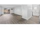 Spacious living area with luxury vinyl flooring, sliding glass door to outside patio, and open kitchen at 6455 E Bates Ave # 3-102, Denver, CO 80222