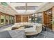 Bright lobby area with a curved sofa, skylights, and large windows providing ample sunlight at 6455 E Bates Ave # 3-102, Denver, CO 80222