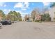 Wide view of apartment complex with parking lot and surrounding greenery at 6455 E Bates Ave # 3-102, Denver, CO 80222