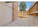 Concrete patio area enclosed by a wood fence and stucco wall at 6455 E Bates Ave # 3-102, Denver, CO 80222