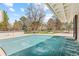 Community pool area with pool cover and landscaping at 6455 E Bates Ave # 3-102, Denver, CO 80222