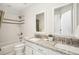 Bright bathroom featuring double sinks with granite countertops, a shower over the tub, and tile flooring at 1290 S Milwaukee St, Denver, CO 80210