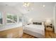 Sun-filled bedroom with hardwood floors, a ceiling fan, and an ensuite with double doors and large windows at 1290 S Milwaukee St, Denver, CO 80210