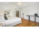 Bright bedroom featuring hardwood floors, a ceiling fan, recessed lighting, and views of the ensuite at 1290 S Milwaukee St, Denver, CO 80210