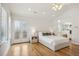 Bedroom featuring hardwood floors, stylish shutters, and double doors leading to the ensuite and living area at 1290 S Milwaukee St, Denver, CO 80210