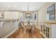 Cozy dining area featuring a round table, bay window with shutters, and hardwood floors at 1290 S Milwaukee St, Denver, CO 80210