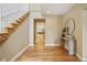 Welcoming foyer with hardwood floors, staircase, console table with plant, and view into kitchen at 1290 S Milwaukee St, Denver, CO 80210