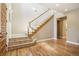 Grand foyer with wooden staircase, tile landing, hardwood floors, and ample natural light at 1290 S Milwaukee St, Denver, CO 80210