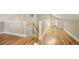 Upstairs hallway showcasing hardwood floors and a view of the staircase at 1290 S Milwaukee St, Denver, CO 80210